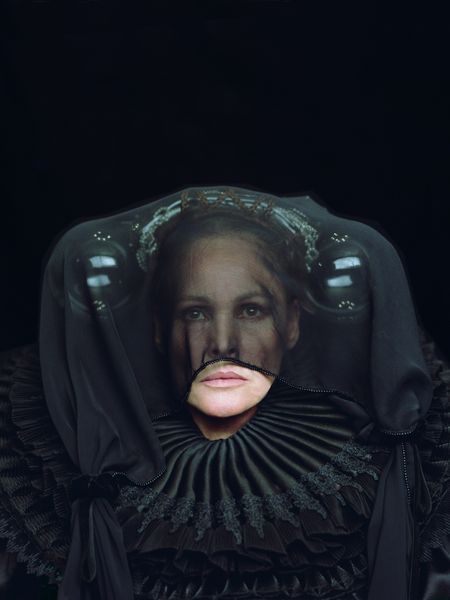This production still features a portrait of a woman dressed in black with a sweeping ruff, eccentric headdress and translucent veil.