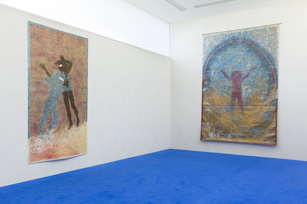 Exhibition view in the building of the Sammlung Goetz with two large-format paintings by the artist Michael Buthe on its white walls and blue inlaid carpeting.