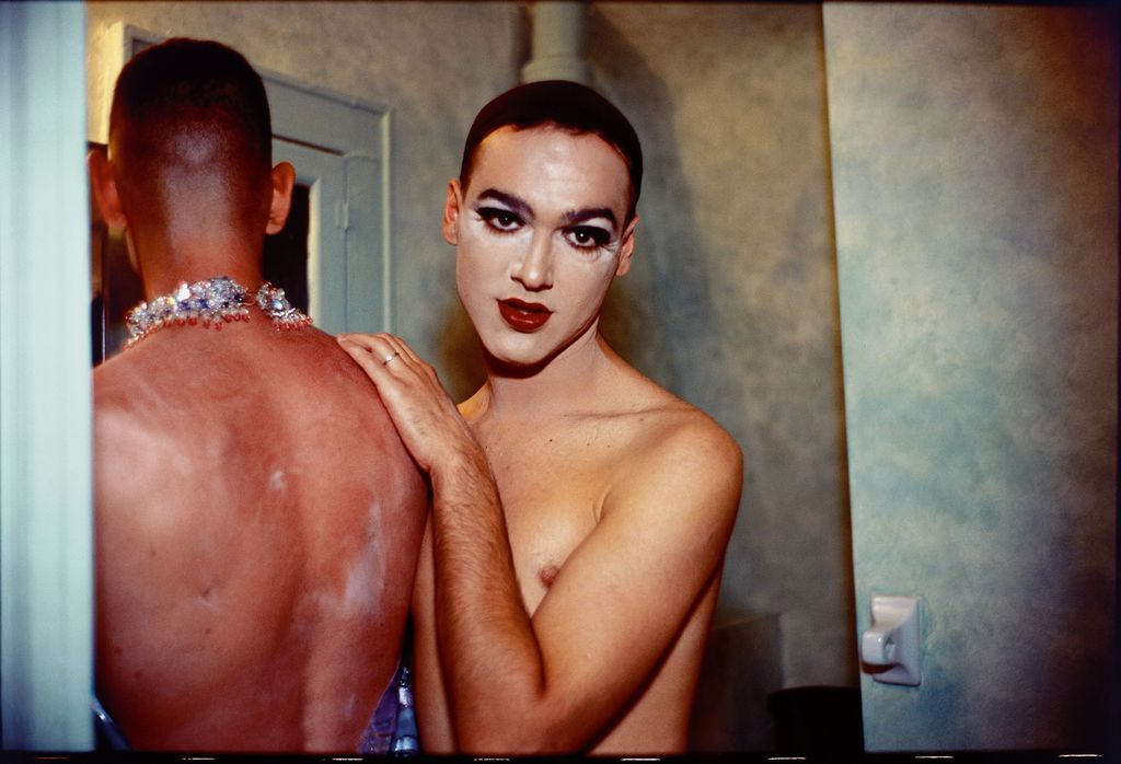 This is an intimate portrait of two drag queens, one standing with her back to the viewer, the other looking into the camera as they appear to be changing for a show. Nan Goldin, Sammlung Goetz Munich