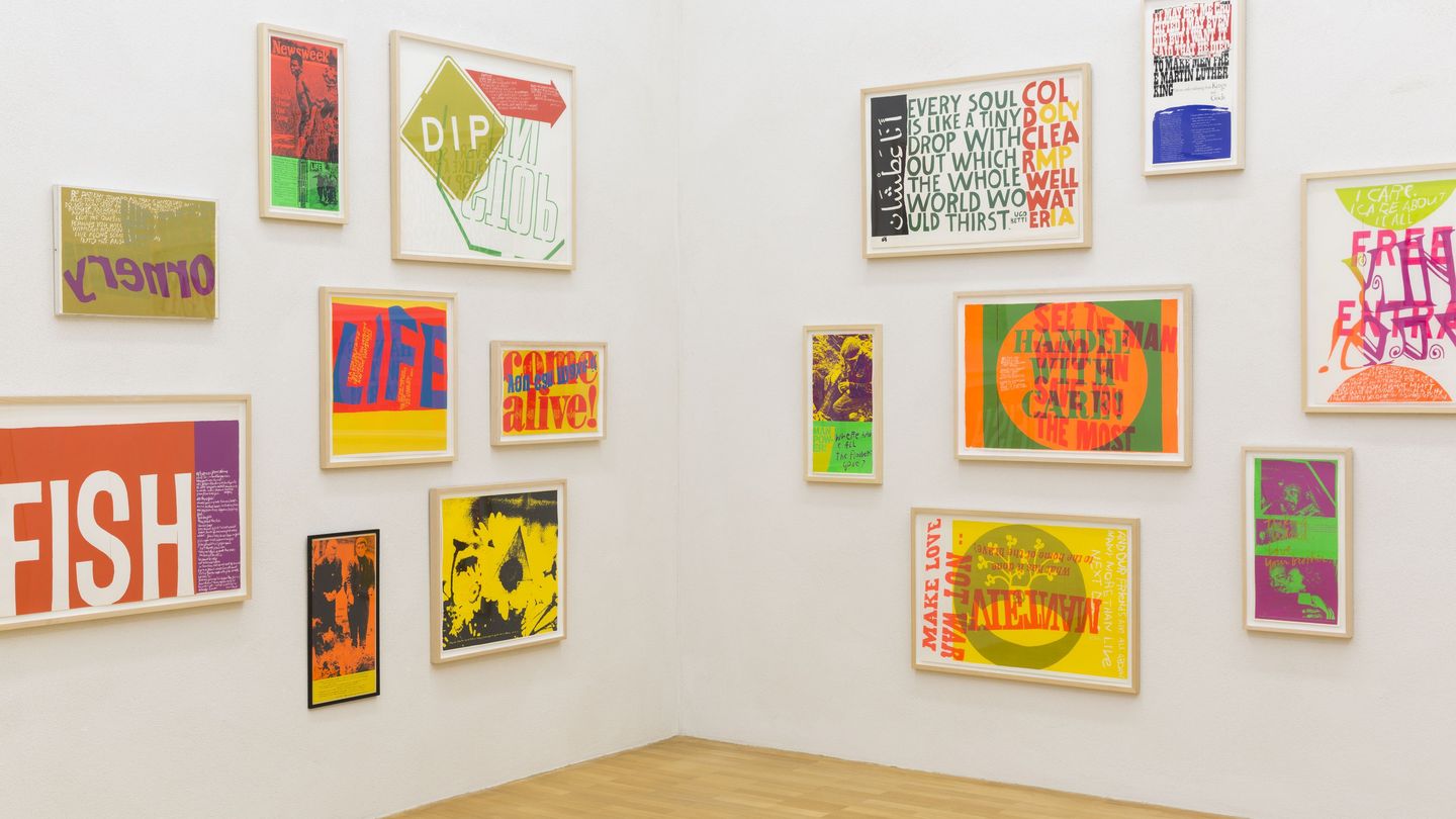 View of a corner of an exhibition room in the Sammlung Goetz, with different sized, framed and multi-coloured silkscreen prints placed on both walls. Sister Mary Corita Kent, Sammlung Goetz Munich