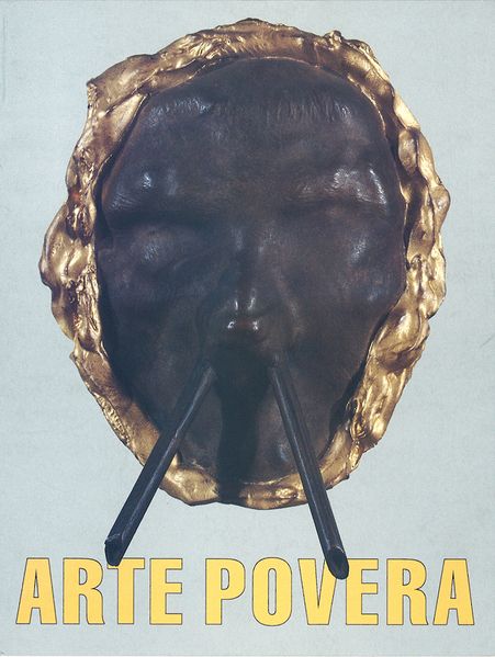 This view includes a flyer card for the Arte Povera exhibition in Gothenburg. At the bottom are the words Arte Povera in yellow letters. Above it is a sculpture with features of a face and a golden, irregular rim. Two sticks seem to come out of the "nostrils".
