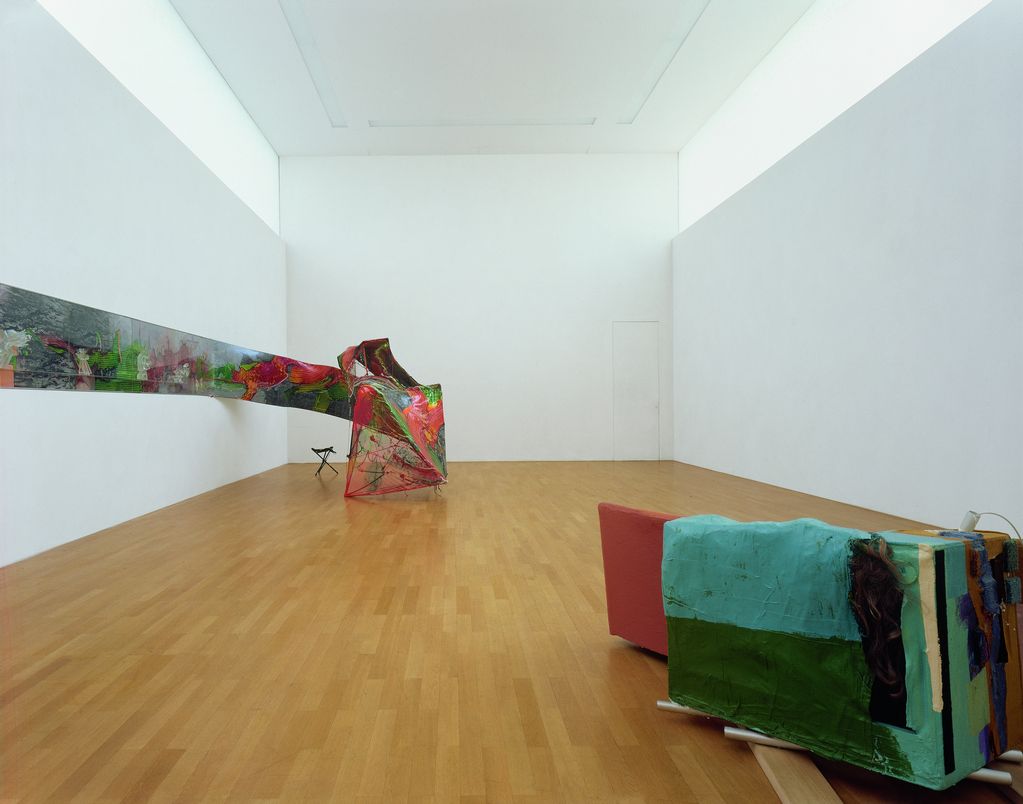 Diese Ausstellungsansicht zeigt jeweils eine dreidimensional Arbeit von Fabian Marcaccio und Jessica Stockholder. Dabei geht es um Farbe, Materialität und ihre Zusammensetzung. 