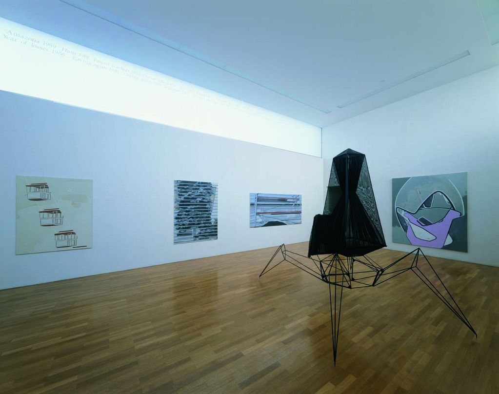 View of the exhibition with a black object in the right part of the picture; on the walls are paintings, most of which are abstract. Veron Urdarianu/Eberhard Havekost/Frank Nitsche/Julian Göthe, Sammlung Goetz Munich