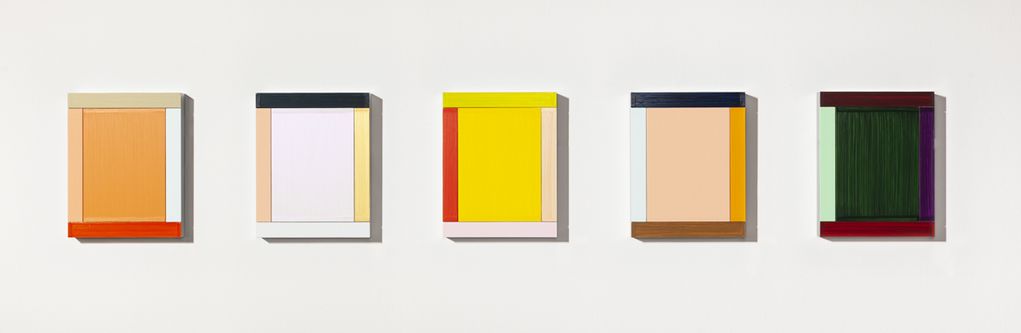 Five rectangular geometric abstract wall objects hang side by side. Each object consists of a monochromatic rectangular surface framed by four narrow stripes in different colors. The paint was applied in regular, clearly visible brushstrokes 
