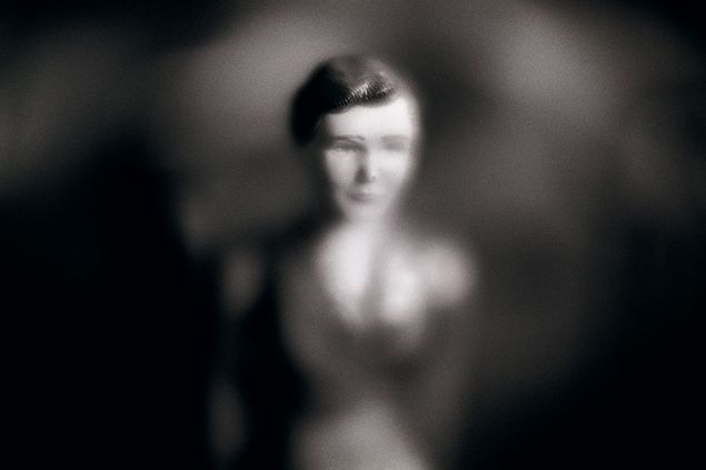A close-up of a Playmobil figure in black and white. The outlines are very blurred, giving the photo the look of a romanticized portrait of the figure. 
