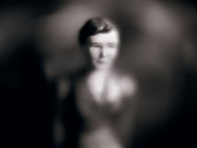 A close-up of a Playmobil figure in black and white. The outlines are very blurred, giving the photo the look of a romanticized portrait of the figure. 
