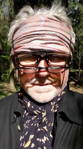 Portrait of the artist Jochen Kuhn with headscarf and several pairs of eyeglasses on his nose, Sammlung Goetz, Munich 