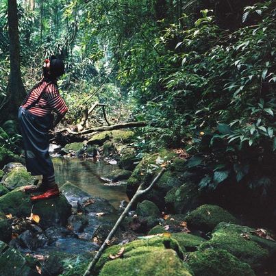 © Julian Rosefeldt/VG BILD-KUNST, Bonn Colour photograph, a clown stands in a forest next to a small stream and looks up into the sky, Julian Rosefeldt, Sammlung Goetz, Munich