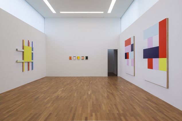 Exhibition view with geometric abstract wall objects by Imi Knoebel.