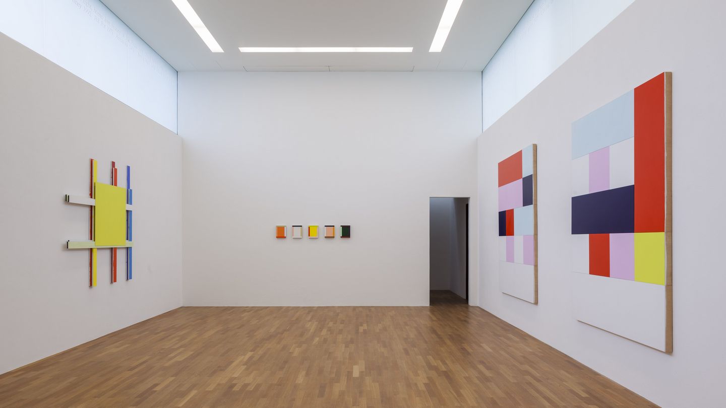 Exhibition view with geometric abstract wall objects by Imi Knoebel.