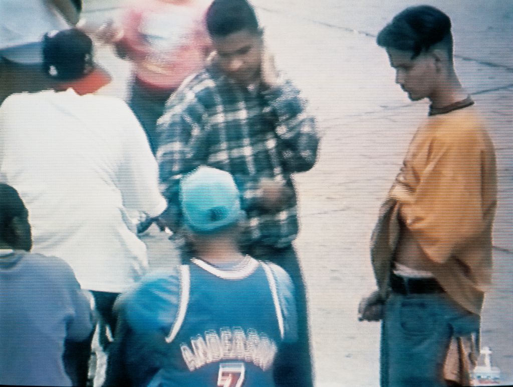 Here we see a street scene with young men who are apparently unaware of the view through the camera. 