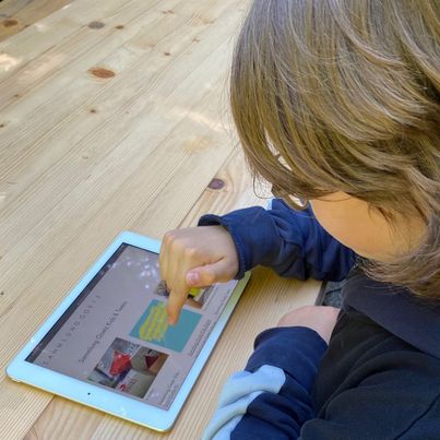 Child with ipad. Link to the digital educational program