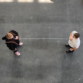 © Elmgreen & Dragset/VG BILD-KUNST, Bonn Bird's eye view of the two artists in their studio measuring the distance between them with a string