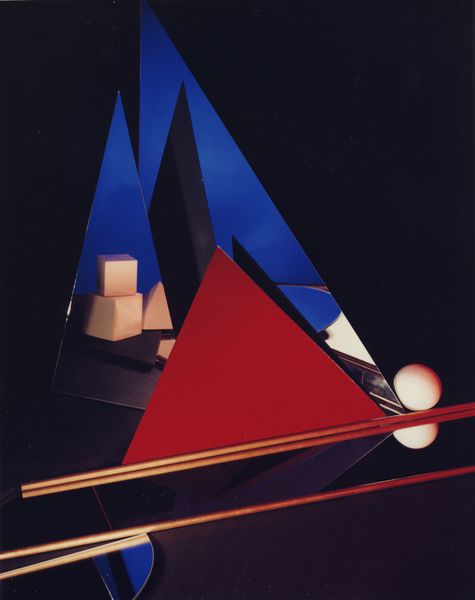 Color photograph of an abstract geometric composition made of triangular mirrors and geometric volumes (cubes, spheres), Barbara Kasten, Sammlung Goetz, Munich.