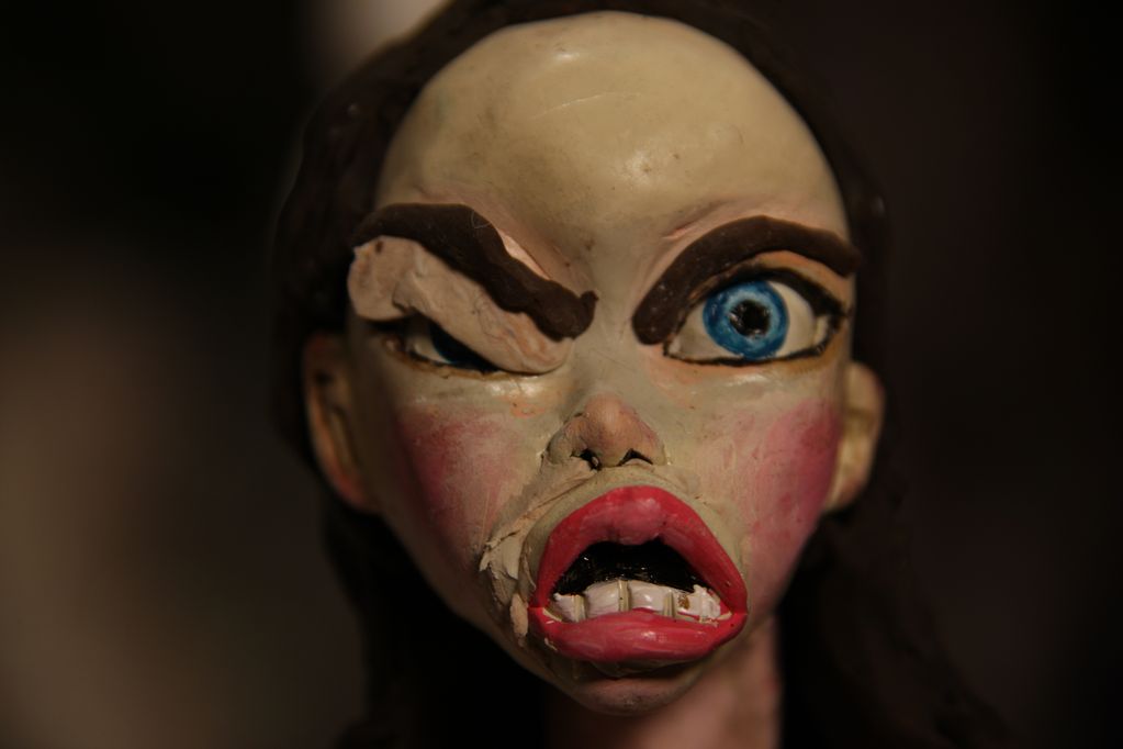 Head of female plasticine figure making a grimace